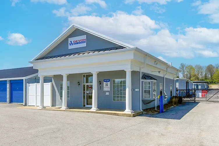 Self storage office building with covered entrance, columns, and nearby gated access