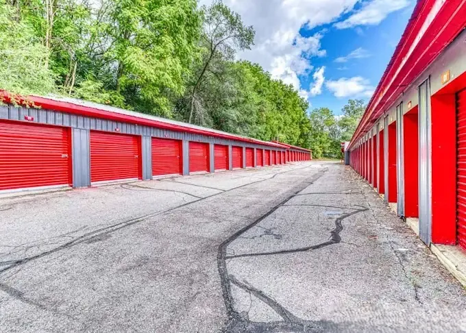 Wide driveway with drive up units and roll up doors.
