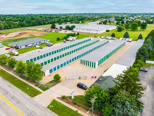 Aerial view of self storage facility with multiple drive-up unit buildings along main road
