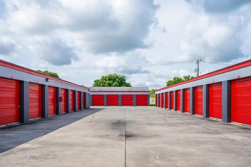 Wide driveway with drive up units and roll up doors.