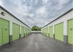 Wide driveway with drive up units and roll up doors.