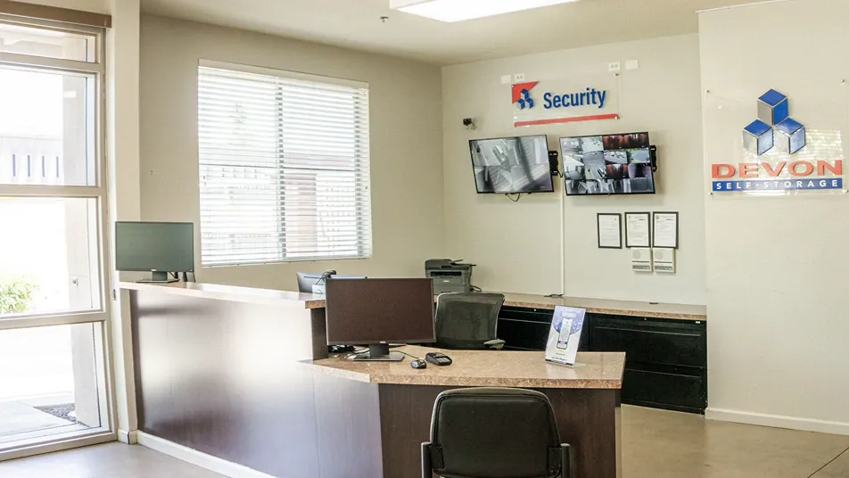 Storage office with customer service desk and security camera monitoring system