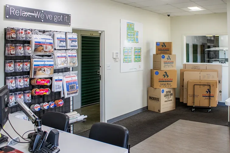 Self storage office interior with moving supplies, packing materials, and storage boxes