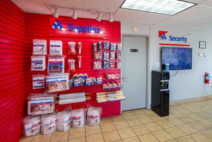 Moving supplies and packing materials available inside storage office with security monitoring