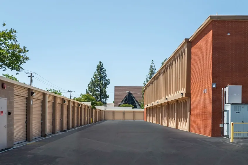Drive-up storage units alongside multi-story storage building with wide access lane