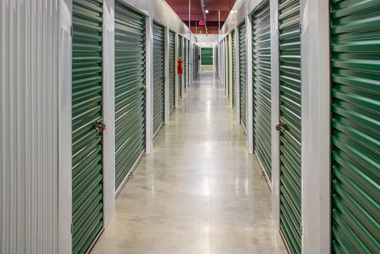 Indoor storage corridor with rows of secure units and polished concrete flooring