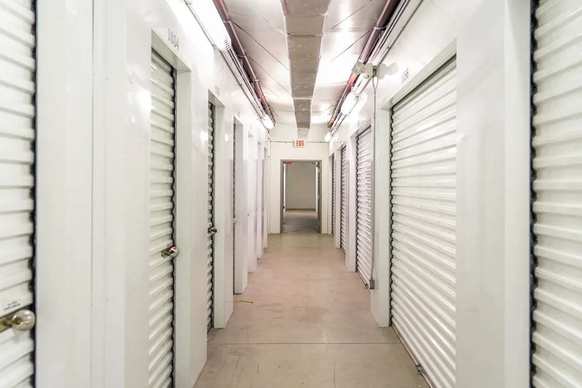 Indoor storage hallway with secure roll-up units inside facility