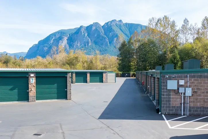 Drive-up storage units with roll-up doors and mountain views in background