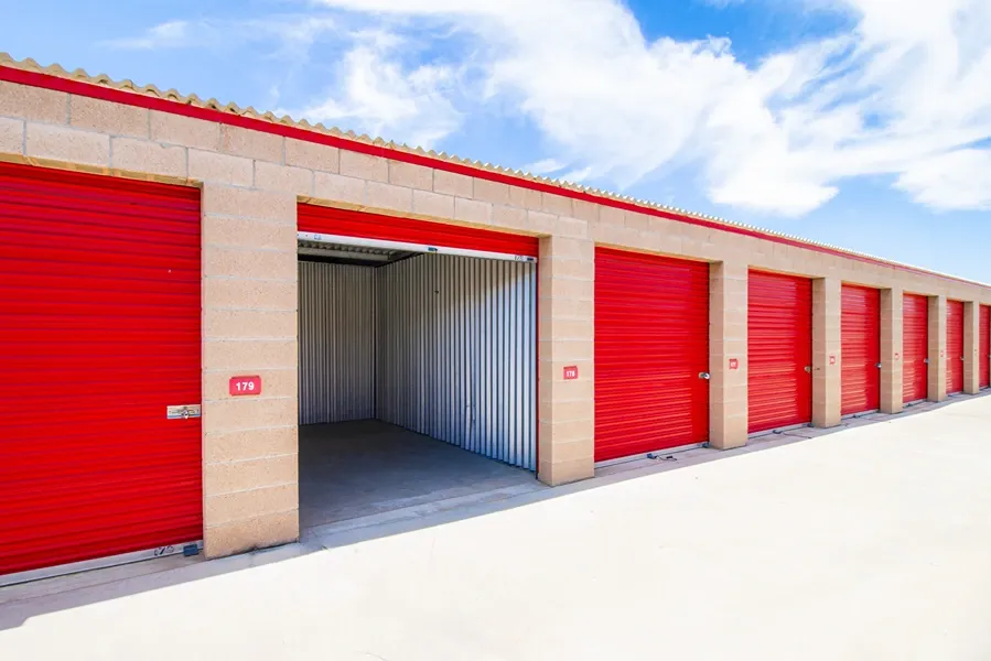 Up close of opened, large storage unit with red doors in Apple Valley, CA, at Devon Self Storage - Highway 18 #1