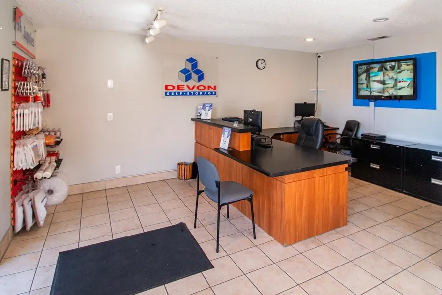 Interior office and security monitoring station of a self-storage facility, showing a front desk