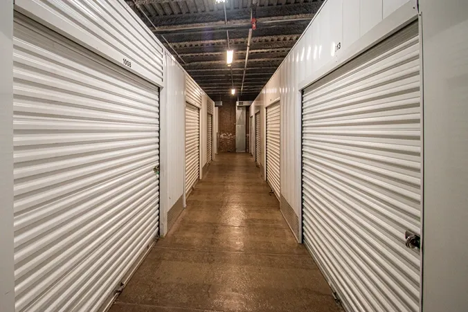 Indoor self storage hallway with secure roll-up units on both sides