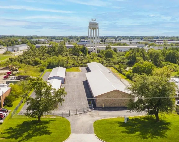 Aerial view of self storage facility with multiple buildings and nearby water tower