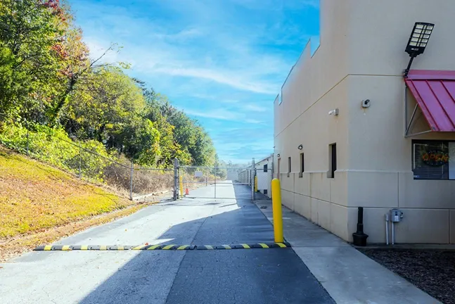Storage facility drive lane with gated access and perimeter fencing for security